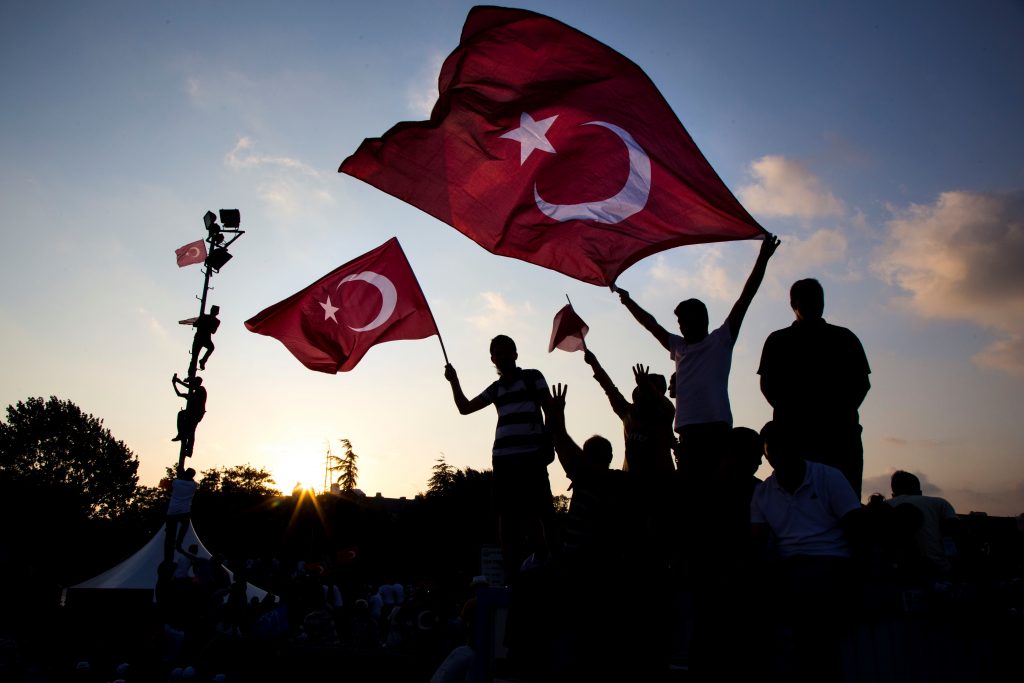 ISTANBUL, TURKEY - AUGUST 7: People hold Turkish flags as they take part in Democracy and Martyrs' Rally, held to protest against the July 15 failed coup by the Fetullah Terrorist Organization (FETO), at Yenikapi in Istanbul, Turkey on August 7, 2016. Turkish officials accuse U.S.-based Turkish citizen Fetullah Gulen plotting to overthrow the government of President Erdogan as the culmination of a long running campaign to infiltrate Turkish institutions including the military, the police and the judiciary. (Photo by Muhammed Enes Yildirim/Anadolu Agency/Getty Images)
